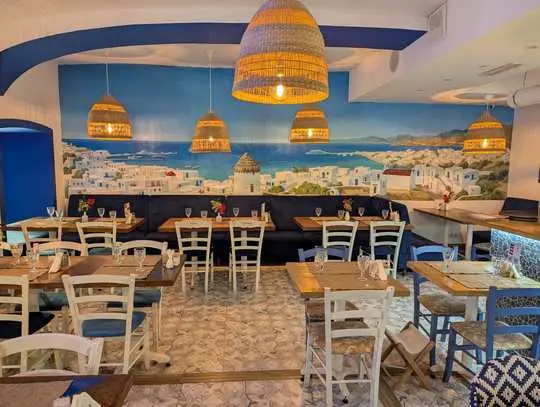 taverna dining room with a mural of Mykonos