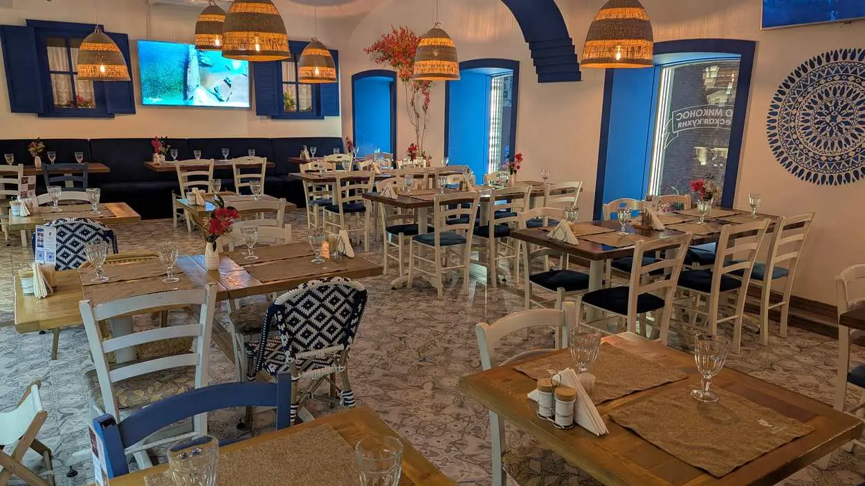 the taverna's main dining room with wicker lamps